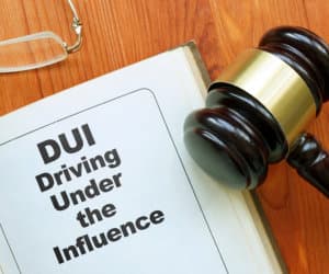 Conceptual hand written text is showing DUI driving under the influence